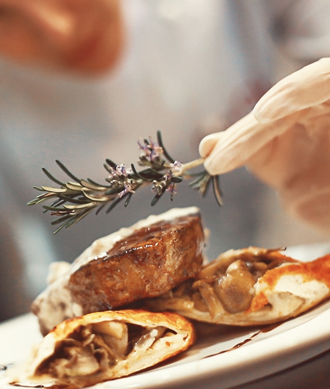 Professional chef putting a final touch on a meal